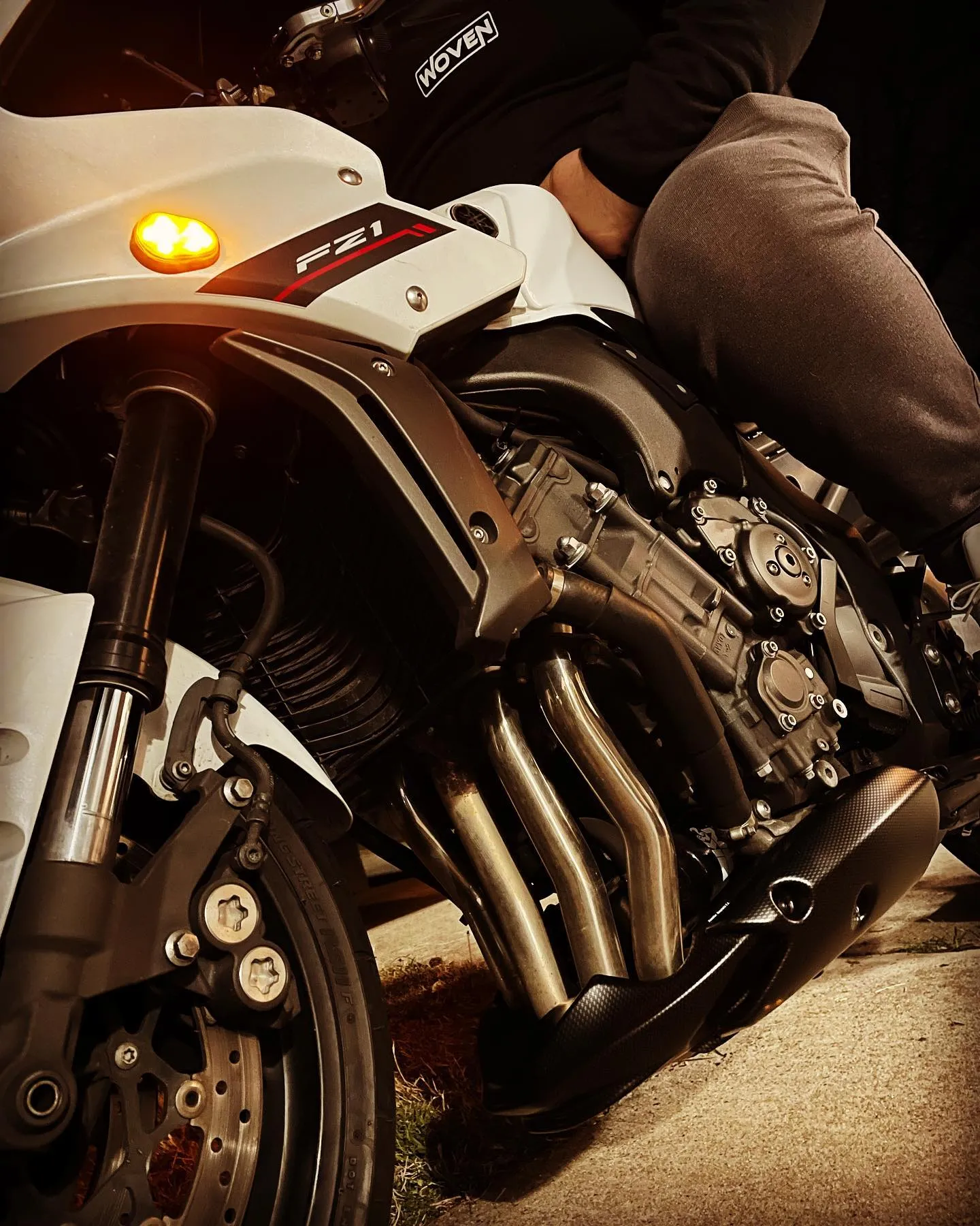 Rider seated on a white motorcycle